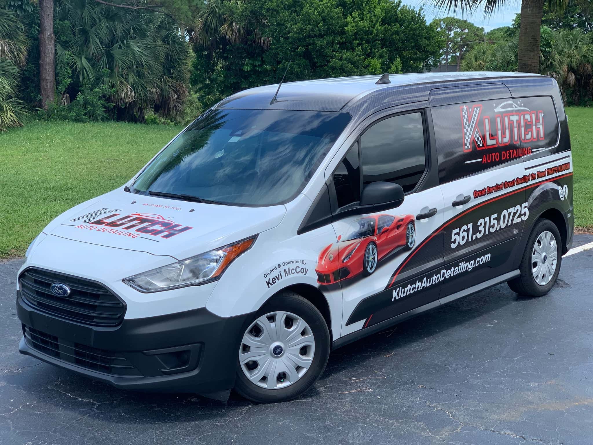 The KLUTCH Auto Detailing van, wrapped in the black, white, and red racing livery